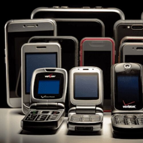 An assortment of mobile phones including flip phones and smartphones